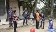 Bangladeshi security personnel search people at an entrance to the Hazrat Shahjalal International Airport in Dhaka on February 25, 2019, as Bangladesh's authorities boost up security the day after an attempted plane hijack.  AFP / Munir Uz Zaman 