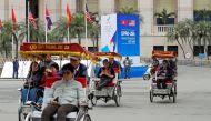 Rickshaws transport tourists next to a sign for the upcoming North Korea-U.S. summit, near the Metropole hotel in Hanoi, Vietnam, February 25, 2019. REUTERS/Kim Kyung-Hoon