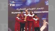Qatari fencers pose for a photograph with their medals and trophies during the Arab Fencing Championship in Kuwait.