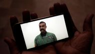 A man watches a statement of Indian Air Force pilot Abhinandan Varthaman on his mobile phone, released on twitter by the Ministry of Information & Broadcasting, in Karachi, Pakistan March 1, 2019. Reuters/Akhtar Soomro 