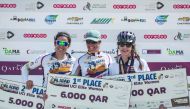 Finland’s Pia Sundstedt, the winner of the Elite category at the  fourth edition of Al Adaid Desert Challenge  poses for a picture along with second place finisher Tala Abujbara  of Qatar and Marwa El Hage of Lebanon.