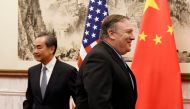 FILE PHOTO: U.S. Secretary of State Mike Pompeo is seen near Chinese State Councilor and Foreign Minister Wang Yi before a meeting at the Diaoyutai State Guesthouse in Beijing, China October 8, 2018. Daisuke Suzuki/Pool via Reuters/File Photo