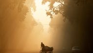 FILE PHOTO: A man rides a rickshaw on a smoggy morning in New Delhi, India, December 26, 2018. REUTERS/Adnan Abidi