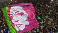 A flag depicting the image of murdered council woman Marielle Franco is seen during the second night of Rio's Carnival parade at the Sambadrome in Rio de Janeiro, on March 5, 2019. AFP / Carl De Souza 