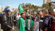 Algerian protestors face anti-riot police during a demonstration in the northern coastal city of Oran, on March 5, 2019 against the ailing president's bid for a fifth term. AFP 
