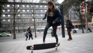 This file picture taken on February 11, 2019 shows longboarder Mu Qing flipping her board in Chengdu. / AFP / Fred DUFOUR 