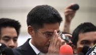 Thai Raksa Chart party leader Preechaphol Pongpanich gestures to journalists after the Constitutional Court ruling to dissolve the party in Bangkok on March 7, 2019. AFP / Lillian SUWANRUMPHA