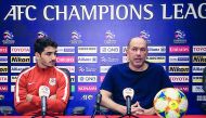 Al Rayyan coach Gilson Souza (right) speaks during a press conference as defender Mohamed Al Aaeldin looks on.   