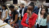 A handout photo by UNEP shows the UN Staff observing a minute of silence for the victims of the accident of the Ethiopian Airlines, including 19 UN workers, before the opening plenary of the 4th UN Environment Assembly at the UN headquaters in Nairobi, Ke