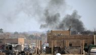 Islamic State members walk in the last besieged neighbourhood in the village of Baghouz, Deir Al Zor province, Syria March 10, 2019. REUTERS/Rodi Said