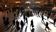 Commuters walk through the morning bright sunlight coming from the 60 feet (18m) high windows in Grand Central Terminal in New York City on March 11, 2019 the first morning after Daylight Savings Time took effect March 10, 2019. AFP / Timothy A Clary 