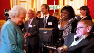 Britain's Queen Elizabeth II (L) meets British astrophysicist Stephen Hawking (R) at a reception for Leonard Cheshire Disability in the State Rooms, St James's Palace, London on May 29, 2014. AFP / Jonathan Brady