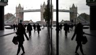 Workers walk through the More London business district with Tower Bridge seen behind in London, Britain, November 11, 2015. Reuters/Toby Melville
