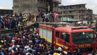 Rescue workers are seen at the site of a collapsed building containing a school in Nigeria's commercial capital of Lagos, Nigeria March 13, 2019. REUTERS/Temilade Adelaja