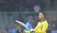 Australia's cricketer Usman Khawaja celebrates after achieving his century (100 runs) during the fifth one-day international (ODI)cricket match between India and Australia at the Feroz Shah Kotla Stadium in New Delhi on March 13, 2019. (AFP / Sajjad HUSSA