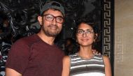 Indian Bollywood actor and producer Aamir Khan (L) along with his wife, film director and screenwriter Kiran Rao Khan (R), pose for photographs on his 54th birthday at his residence in Mumbai on March 14, 2019. / AFP / STR