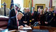 President Donald Trump signs his veto of the congressional resolution to end his emergency declaration to get funds for a border wall during a ceremony in the Oval Office of the White House in Washington, U.S., March 15, 2019. REUTERS/Jonathan Ernst