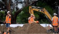 Workers dig grave sites at a cemetery in Christchurch on March 17, 2019 two days after a shooting incident at two mosques in the city. / AFP / Marty MELVILLE 
