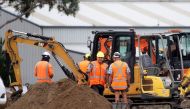 Workers dig grave sites at a cemetery in Christchurch on March 17, 2019 two days after a shooting incident at two mosques in the city.  AFP / Marty Melville 