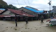 This handout picture taken and released by Indonesia Military on March 18, 2019 shows soldiers looking for survivors in a flooded area in Sentani. AFP PHOTO / INDONESIA MILITARY