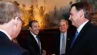 Brazilian President Jair Bolsonaro (R) greeting New Criterion Magazine Editor Roger Kimball (L), Investments Director of Pantera Capital Gerald Brant (2-L) and US President Donald Trump's former strategist Stephen Bannon (2-R) during a meeting with right-