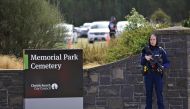 A police officer stands guard as relatives of victims of mosque attack arrive to attend the funeral of a victim who died at the mosque attack at Memorial Park Cemetery, in Christchurch, New Zealand on March 21, 2019.  Peter Adones - Anadolu