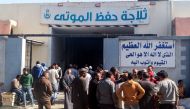 Family-members and relatives of the victims of an explosion at a chemical plant gather outside a morgue to receive their bodies, in the Egyptian Red Sea port city of Suez on March 21, 2019. AFP