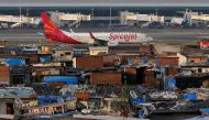A SpiceJet passenger aircraft taxis on the runway at the airport next to a slum area in Mumbai December 19, 2014. Reuters/Shailesh Andrade