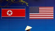 File photo of a person walking past a banner showing North Korean and US flags ahead of the North Korea-US summit in Hanoi, Vietnam, February 25, 2019. REUTERS/Kim Kyung-Hoon
