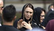 New Zealand's Prime Minister Jacinda Ardern gestures as she departs following a gathering for congregational Friday prayers and two minutes of silence for victims of the twin mosque massacre, at Hagley Park in Christchurch on March 22, 2019.  / AFP / Mart