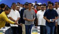 Indonesia's President Joko Widodo (C) walks as he takes part on Jakarta Mass Rapid Transit (MRT) first-phase launching at Istora station in Jakarta, Indonesia, March 24, 2019. REUTERS/Willy Kurniawan