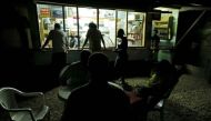 People sit at a kava bar operating with limited electricity days after Cyclone Pam in Port Vila, capital city of the Pacific island nation of Vanuatu March 19, 2015. Reuters/Edgar Su