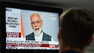 A man watches Indian Prime Minister Narendra Modi's address to the nation on a local news channel in New Delhi on March 27, 2019. AFP / Prakash SINGH