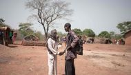 Awatche's self-defence leader shakes hands with a Fulani breeder, on March 17, 2019.  AFP / Florent Vergnes 