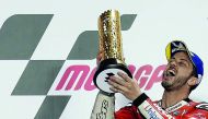Mission Winnow Ducati’s Andrea Dovizioso celebrates with a trophy on the podium after winning the MotoGP race during the VisitQatar Grand Prix at the Losail International Circuit.