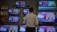 A salesman watches Prime Minister Narendra Modi addressing to the nation, on TV screens inside a showroom in Mumbai, India, March 27, 2019. Reuters/Francis Mascarenhas