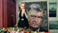 Ukrainian artist Daria Marchenko eats a candy as she creates a large-scale artwork entitled 