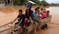 People sit on a locally made vehicle as they travel during the flood after the Xepian-Xe Nam Noy hydropower dam collapsed in Attapeu province, Laos July 26, 2018. Reuters/Soe Zeya Tun