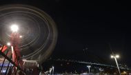 The Sydney Harbour Bridge, the Opera House and the ferris wheel are seen after their lights went out as seen from Sydney's Luna Park for the Earth Hour environmental campaign on March 30, 2019.  AFP / PETER PARKS