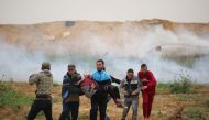 An injured Palestinian is carried away during a protest within the 