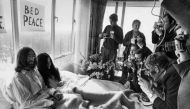 Beatles member John Lennon (L) and his wife Yoko Ono receive journalists in the bedroom of the Hilton hotel in Amsterdam, during their honeymoon in Europe on March 25, 1969. AFP / ANP 