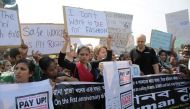 Protesters and activists hold placards on the first year anniversary of the collapse of Rana Plaza as they gather in Savar April 24, 2014. Reuters/Andrew Biraj