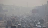 (FILES) In this file photo taken on December 6, 2018, Indian commuters drive amidst heavy smog along a busy road past the South Extension area of New Delhi. AFP / XAVIER GALIANA 