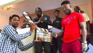 Participants pose during a workshop about filming with a smart-phone on March 30, 2019 as part of the 2nd edition of the Bushman Film Festival, the first Francophone film festival in West Africa focused of smart-phone filming, in Abidjan. AFP / Issouf San