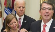 In this file photo taken on February 17, 2015, Secretary of Defense Ashton Carter (R) speaks beside his wife Stephanie and US Vice President Joe Biden during a swearing-in ceremony in the Roosevelt Room of the White House in Washington, DC.  AFP / Saul Lo