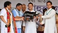 Indian National Congress party president Rahul Gandhi (2R) looks on while being felicitated during an election rally, ahead of the Lok Sabha polls, in Bokakhat, some 240 km from Guwahati, the capital city of India’s northeastern state of Assam on April 3,