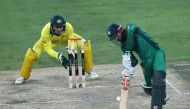 Australian wicketkeeper Alex Carey watches from behind the stumps as Pakistani batsman Muhammad Rizwan plays a shot during the fourth one day international (ODI) between Pakistan and Australia at Dubai International Stadium in Dubai in this March 29, 2019