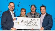 New millionaires Nicole Pedneault and Roger Larocque receives their check from Loto-Quebec's Patrice Lavoie, corporate director of public affairs, and Richard Trudel, director of customer service and prints. (CNW Group / Loto-Québec)