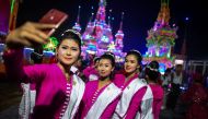 In this picture taken on March 31, 2019, traditional dancers take pictures during abbot Kay Lar Tha's funeral procession in Mudon, Mon State. AFP / Ye Aung Thu
 