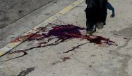 A man passes over a bloodstain in this AFP file photo in a different context. Image used for representation  